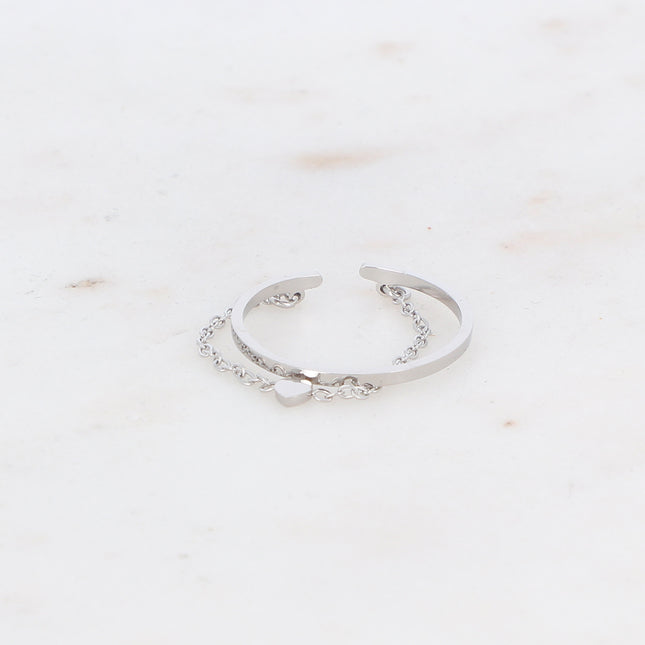 Ring with twisted band and heart on a dangling chain
