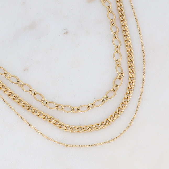 Three-strand necklace with curb links and textured ovals