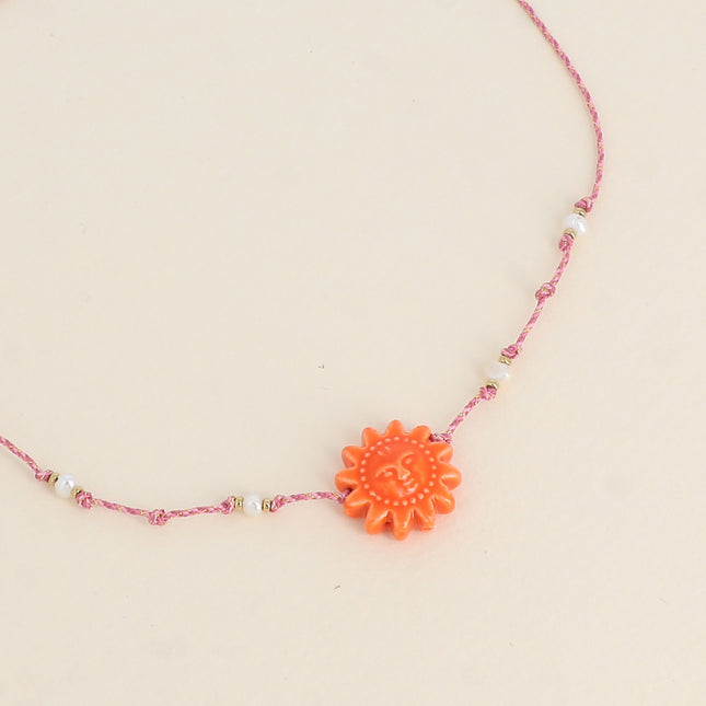 Collier sur cordon - ras de cou, perles d'eau douce et soleil en céramique émailée