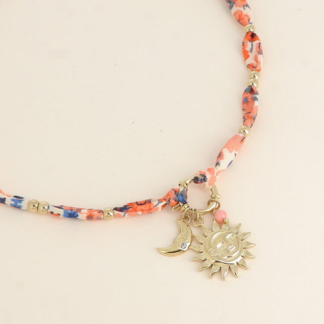 Collier - tissu, fermoir bouée, 3 pendentifs (perle, éclipse soleil, lune et oxyde de zirconium)