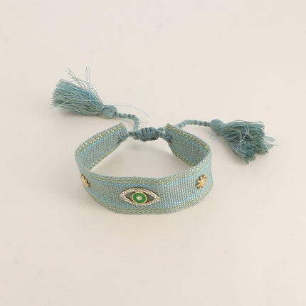 Bracelet en tissu coulissant - oeil en émail et oxydes de zirconium, pompons