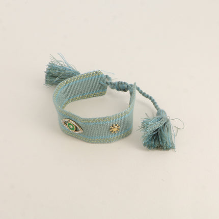 Bracelet en tissu coulissant - oeil en émail et oxydes de zirconium, pompons