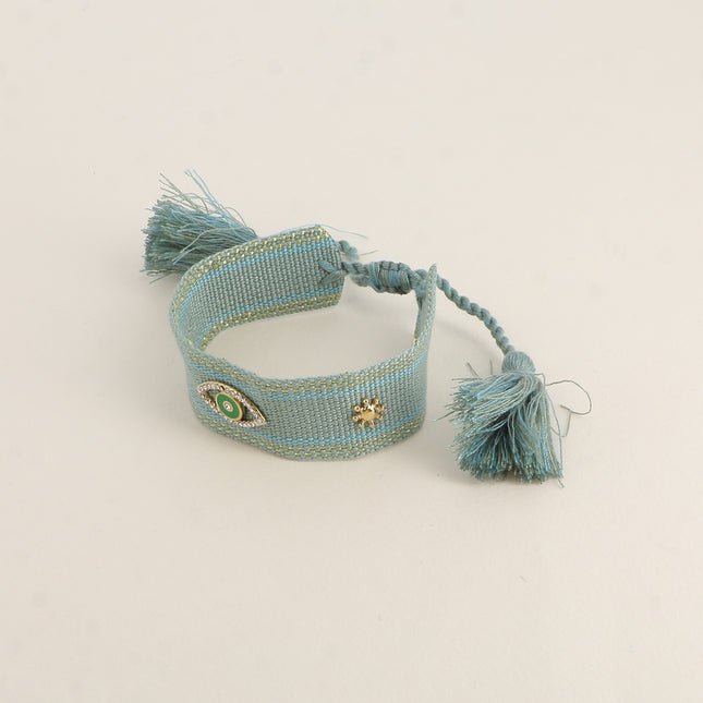 Bracelet en tissu coulissant - oeil en émail et oxydes de zirconium, pompons