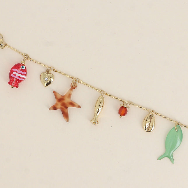 Bracelet - poissons nacré et en résine, cauri, coeur, perle