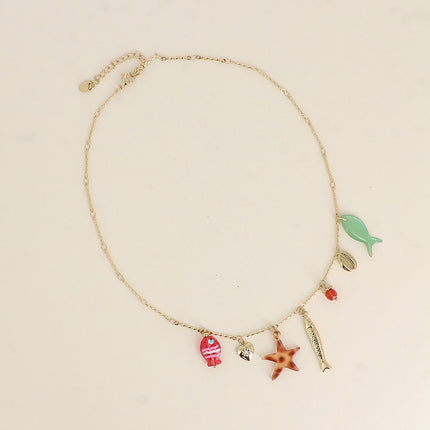 Collier - poissons nacré et en résine, cauri, coeur, perle