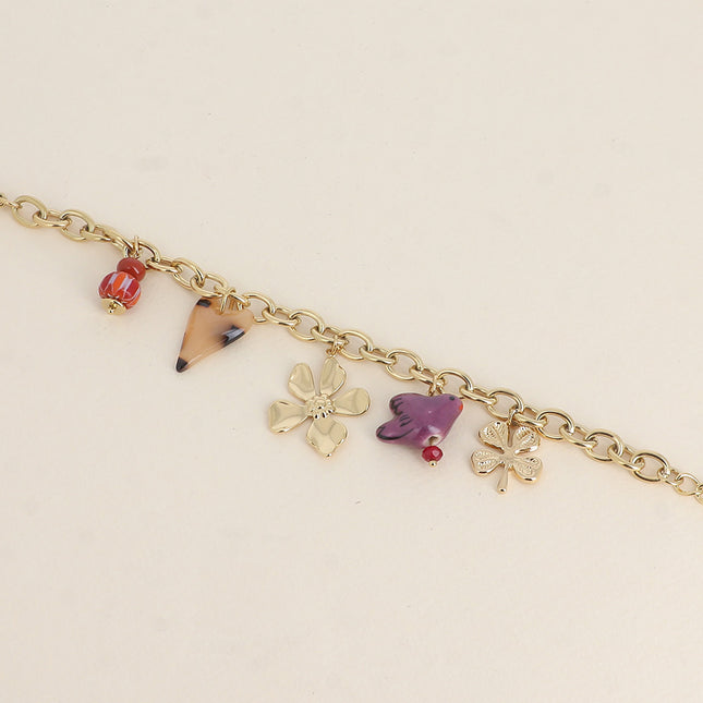 Bracelet - perles et oiseau en céramique, trèfle, coeur en résine et fleur