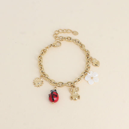 Bracelet - pendentifs (soleil, coccinelle en céramique émaillée, scarabée, fleur nacrée, coeur)
