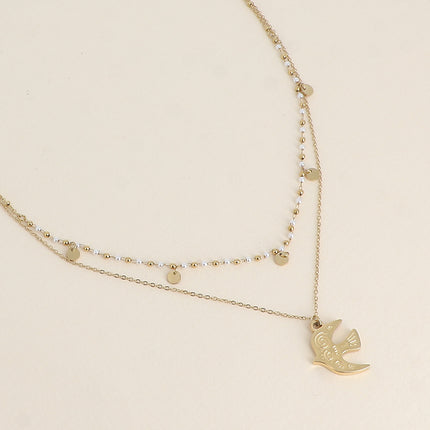 Collier 2 rangs - pendentif en forme d'oiseau, perles de résine blanche