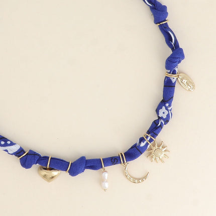 Collier - ruban, breloques (soleil, coeur, la Madone, perles d'eau douce, lune)