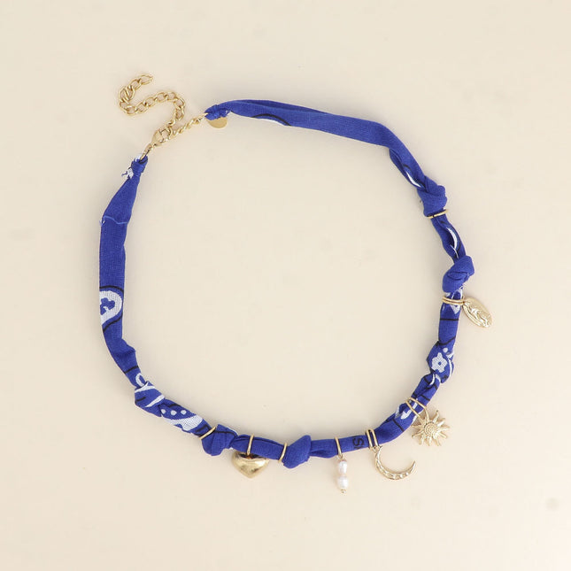 Collier - ruban, breloques (soleil, coeur, la Madone, perles d'eau douce, lune)