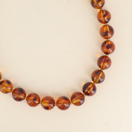 Collier sur câble - perles boules en résine léopard