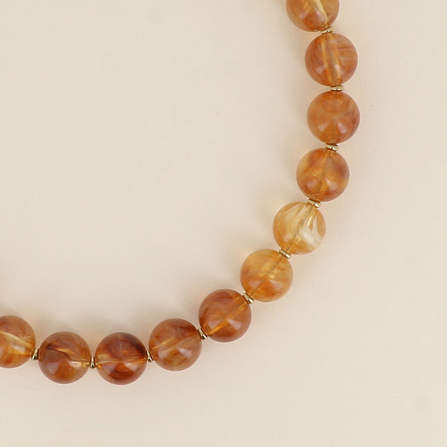 Collier sur câble - perles boules en résine