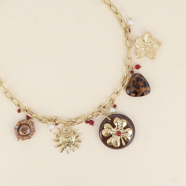 Collier - fleur en céramique émaillée, soleil, trèfle sur pièce ronde en résine, coeur léopard, fleur