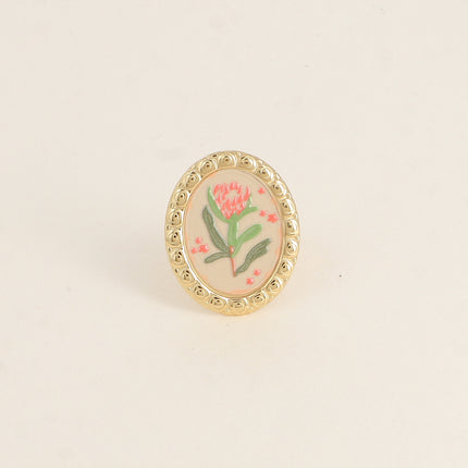 Bague - médaillon avec une fleur émaillée