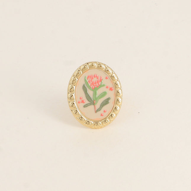 Bague - médaillon avec une fleur émaillée