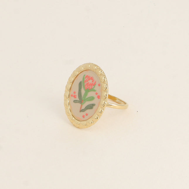 Bague - médaillon avec une fleur émaillée