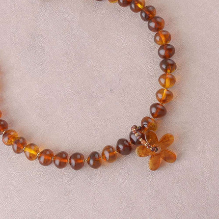 Collier - sur câble avec perles en résine, anneau de pierres naturelles et fleur en résine