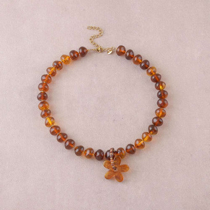 Collier - sur câble avec perles en résine, anneau de pierres naturelles et fleur en résine