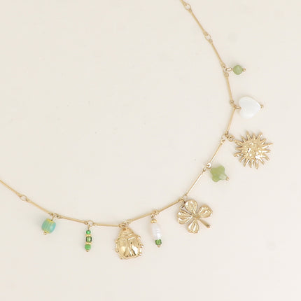 Collier - pendentifs (perles, coccinelle, perle d'eau douce, trèfle, soleil, coeur nacré)