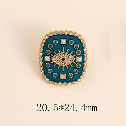 Pin's - médaillon rectangulaire émaillé, oeil avec cristaux