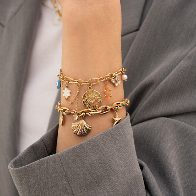 Bracelet Taliya - breloques (oeil et oxydes de zirconium, fleur nacrée, émail, papillon, pierres naturelles)