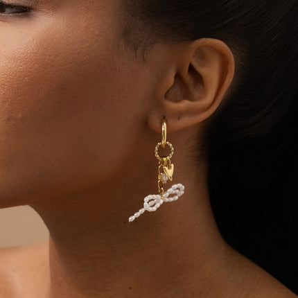 Creole earrings - twisted hoops, bow tie with white resin beads