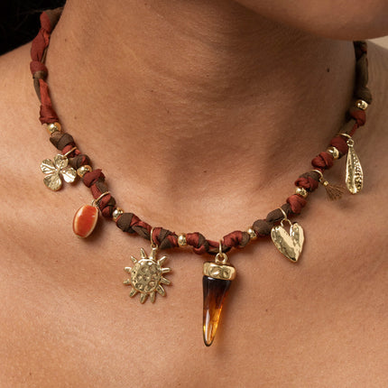 Necklace - ribbon fabric, enameled ceramic bead, sun, resin horn, textured heart