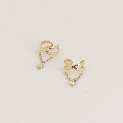 Earcuffs - deux anneaux croisés et un cristal sur une chaîne pendante