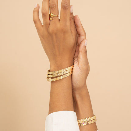 Bangle - small geometric shapes (star, circle, square) engraved and cubic zirconia